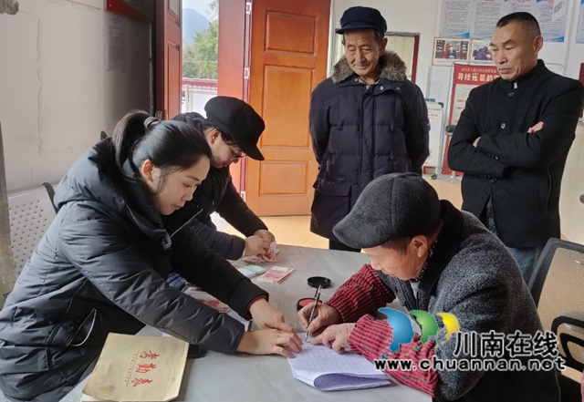 四川省首批金牌劳务经纪人钟丽（左一）在泸县得胜镇上顶山村为部分社员发放工资.jpg